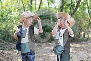 Adventure boys are using a binocular