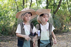 Adventure boys are using a binocular