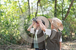 Adventure boys are using a binocular