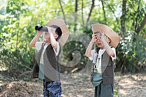 Adventure boys are using a binocular