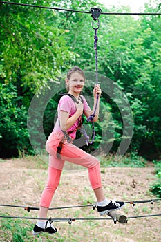 Adventure climbing high wire park - hiking in the rope park girl.