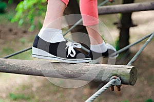 Adventure climbing high wire park - hiking in the rope park girl.