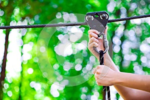 Adventure climbing high wire park - people on course in mountain helmet and safety equipment