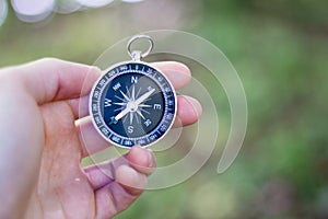 Adventure: Compass in manâ€™s hand, showing the direction