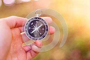 Adventure: Compass in manâ€™s hand, showing the direction