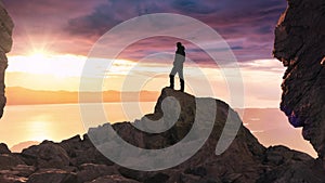 Adventure Composite. Adventurous Adult Man standing on top of a mountain. Sunrise or Sunset.