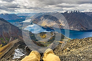 Adventure concept, resting male legs in front of the stunning landscape