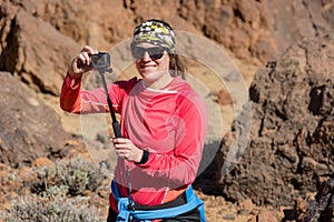 Adventure female vloger using action camera outdoor. photo