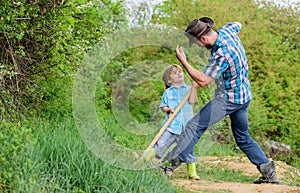 Adventure hunting for treasures. Little helper in garden. Cute child in nature having fun cowboy dad. Find treasures