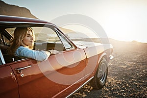 Adventure keeps calling my name. a young woman enjoying a road trip along the coast.