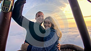 Adventure love couple on hot air balloon watermelon. Man and woman kiss hug love each other. Burner directing flame into