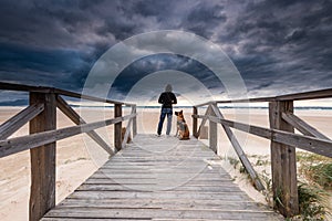Adventure Man and Dog on Remote Beach. Active Outdoors Concept