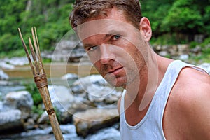 Adventure man exploring jungle river