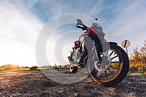 Adventure motorbike on roadside at sunset. Offroad trip