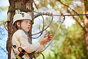 adventure rope park. Girl climbing on tree