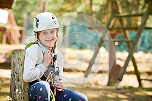 adventure rope park. Girl climbing on tree