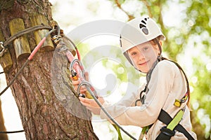 adventure rope park. Girl climbing on tree