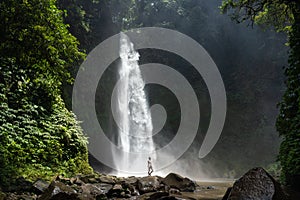 Adventure seeker at beautiful jungle waterfall