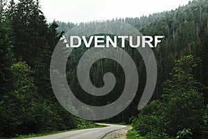 Adventure sign word, beautiful view of road among trees in fores