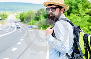 Adventure spirit. Hitchhiking means transportation gained asking strangers for ride in their car. Hitchhiker try to stop photo