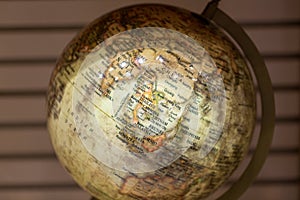 Adventure stories background. Old globe on map background.