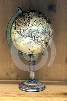 Adventure stories background. Old globe on map background.