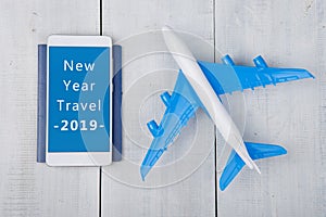 Adventure time - plane, passport and smartphone with text "New Year Travel 2019 photo