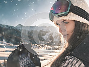 Adventure to winter sport. Snowboarder girl at Alps