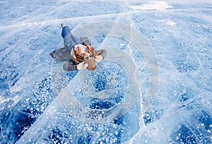 Adventure Tourist woman background ice with gas methane bubbles lake Baikal winter travel