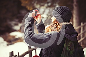 Adventure tourist woman taking a picture. Hiking