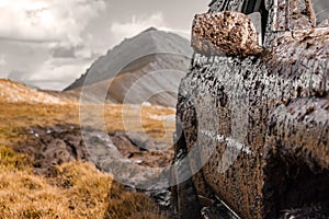 Adventure travel concept background. 4x4 off-road suv car stuck in mud.