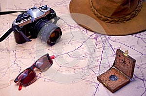 adventure travel equipment with camera, hat, sunglasses and compass