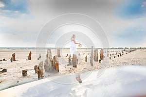 Adventure travel lifestyle concept. abandoned salt production. Salt lane enclosed by dried wooden pillars on a salt lake.