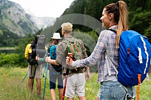 Adventure, travel, tourism, hike and people concept. Group of happy friends with backpack outdoors