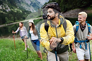 Adventure, travel, tourism, hike and people concept. Group of happy friends with backpack outdoors