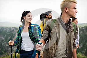 Adventure, travel, tourism, hike and people concept. Group of happy friends with backpack outdoors