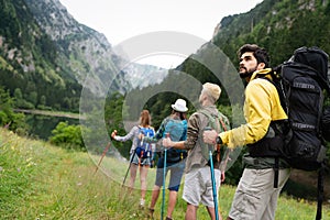 Adventure, travel, tourism, hike and people concept. Group of happy friends with backpack outdoors