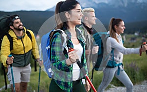 Adventure, travel, tourism, hike and people concept - group of smiling friends with backpacks and map outdoors