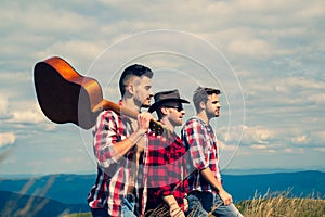 Adventure travel tourism hike and people concept - group of smiling friends walking on a mountain. Group of young