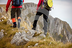 Adventure, travel, tourism, hike and people concept - smiling couple walking with backpacks outdoors