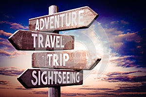 Adventure, travel, trip, sightseeing - wooden signpost, roadsign with four arrows
