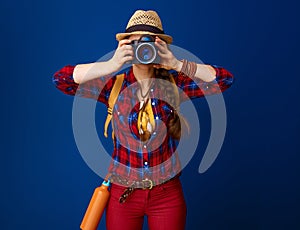 Adventure traveller woman taking photo with digital camera