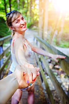 Adventure in the woodland: Girl is holding her boyfriends hand for a new adventure