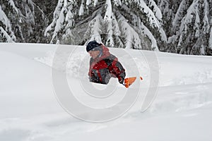 Adventurer digs a cave in the snow during a snowfall