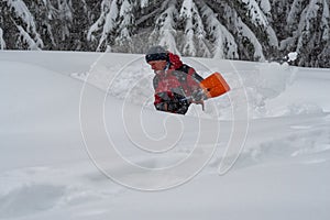 Adventurer digs a cave in the snow during a snowfall