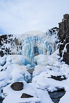 Adventurer next to ÃâxarÃÂ¡rfoss Waterfall at Thingvellir National Park Iceland