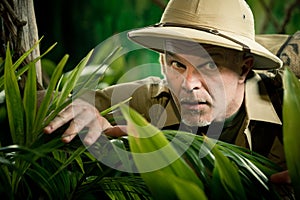 Adventurer peeking through plants