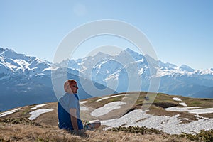 Adventurer is relaxing on the mountain slope