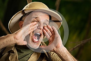 Adventurer shouting in the jungle photo