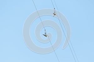 adventurers fly down a zip line rope in an extreme rope park